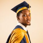 young graduate in cap and gown portrait