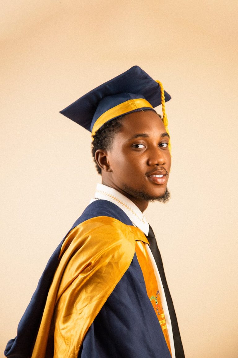 young graduate in cap and gown portrait