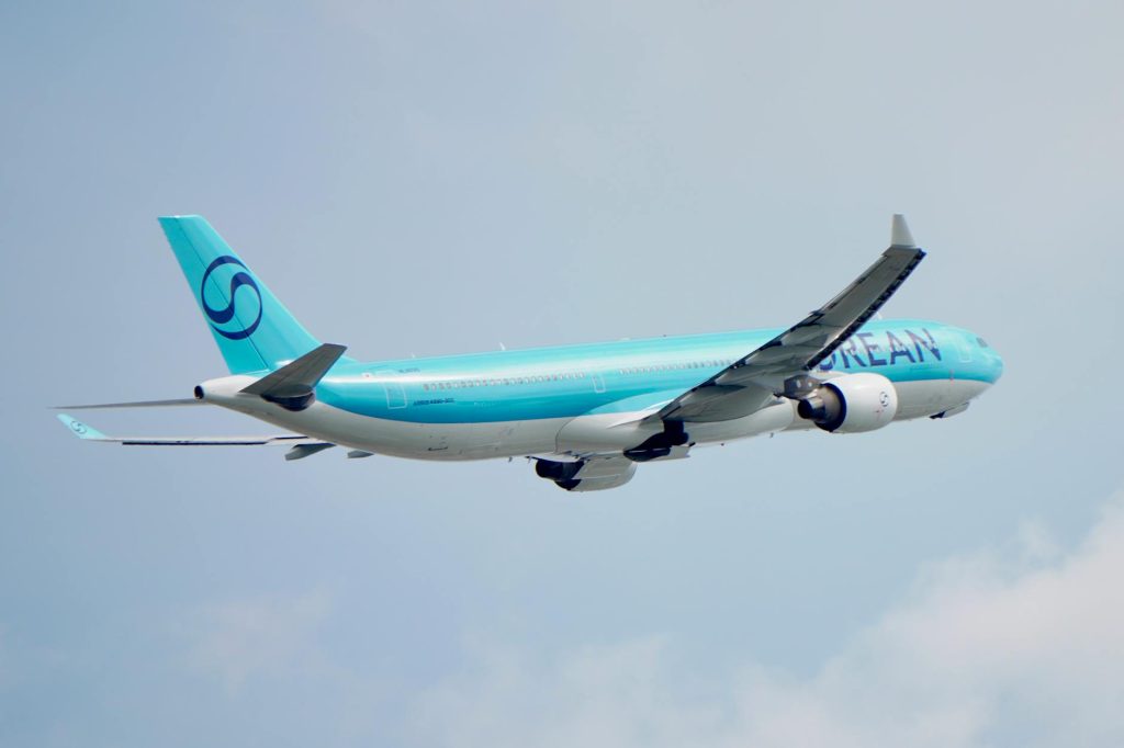 commercial airliner soaring in clear blue sky